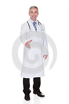 Portrait Of Happy Mature Male Doctor Offering Handshake