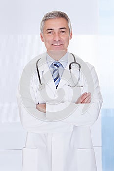 Portrait of happy mature male doctor