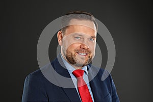 Portrait of happy mature man on black background