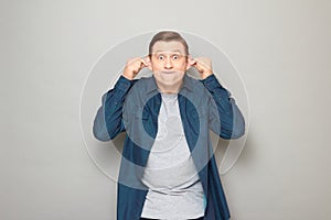 Portrait of happy mature man fooling around and making funny face