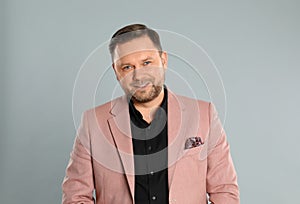 Portrait of happy mature man on light grey background