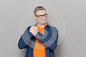 Portrait of happy mature man raising and holding hands clasped