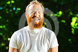 Portrait of happy mature man with red beard and mustache