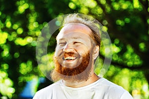 Portrait of happy mature man with red beard and mustache