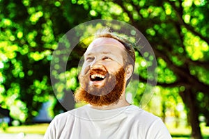 Portrait of happy mature man with red beard and mustache