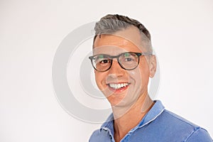 Portrait of happy mature man wearing glasses smiling at camera
