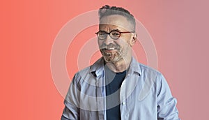 Portrait of happy mature man wearing spectacles and looking at camera isolated studio background.