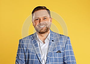 Portrait of happy mature man on yellow background