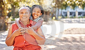 Portrait happy mature woman and her granddaughter spending quality time together in the park during summer. Cute little