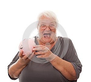 Portrait of a happy mature woman holding piggy bank isolated against white