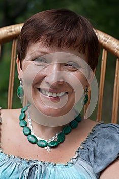 Portrait of happy mature woman in malachite bijou