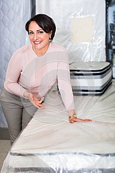 Portrait of happy mature woman with matress