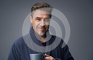 Portrait of happy mid adult man drinking morning coffee