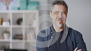 Portrait of happy middle aged casual man at home smiling