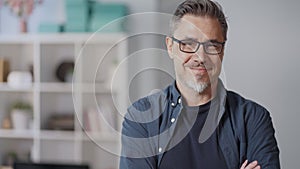 Portrait of happy middle aged casual man at home smiling