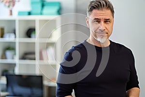 Portrait of happy middle aged casual man at home smiling