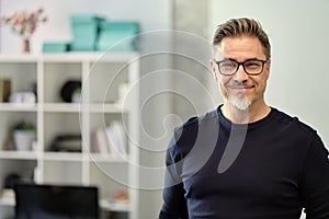 Portrait of happy middle aged casual man at home smiling