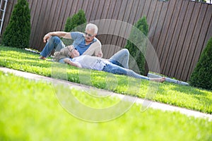 Portrait of happy of middle aged couple on a green grass