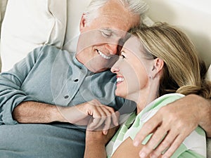 Portrait of a happy middle aged couple showing affection in bed