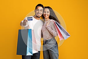 Portrait Of Happy Middle Eastern Couple With Credit Card And Shopping Bags