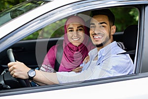 Portrait Of Happy Middle Eastern Spouses Posing In Their New Automobile