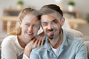 Portrait of happy millennial couple looking at camera, head shot