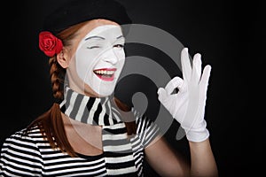 Portrait of a happy mime comedian showing OK