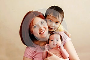 Portrait of happy mixed race family: mother with two children, infant baby girl and toddler son