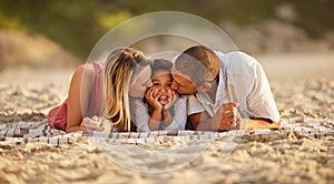 Portrait of a happy mixed race family spending time together on the beach. Adorable little girl enjoying vacation with