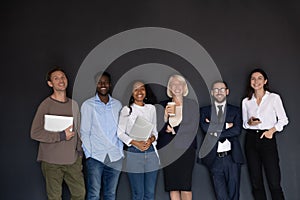 Portrait of happy mixed race older and young employees.