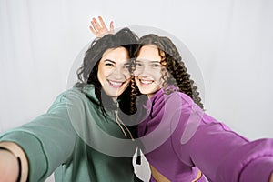 Portrait of happy mom and teen daughter spend time together. Teenage girl hugging her mother and having fun together