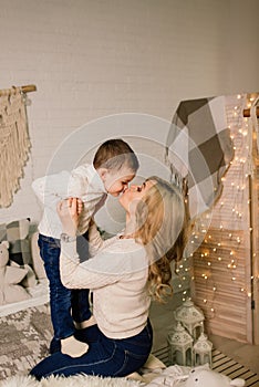 Portrait of happy mother and adorable baby celebrate Christmas. New Year`s holidays