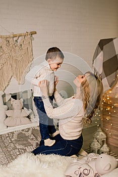 Portrait of happy mother and adorable baby celebrate Christmas. New Year`s holidays