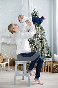 Portrait of happy mother and adorable baby celebrate Christmas.