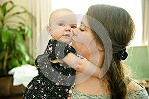 Portrait of a happy mother with cute baby at home