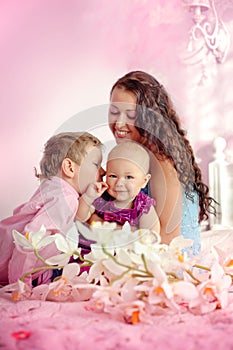 Portrait of a happy mother and her children boy and girl sitting