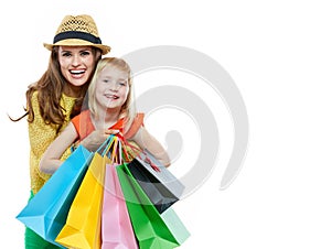 Portrait of happy mother hugging daughter with shopping bags