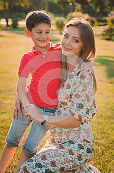 Portrait of a happy mother and son in a summer park. Family concept.