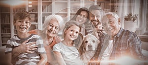 Portrait of happy multi generation family sitting on sofa in living room