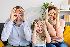 Portrait of happy multi-generational family having fun doing funny faces