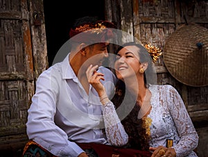 Portrait of happy multicultural couple. Romantic concept. Couple in love. Bamboo house. Caucasian wife and Balinese husband