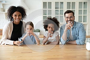 Portrait of happy multiracial family recommend drinking water