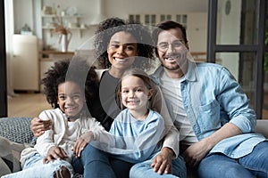 Portrait of happy multiracial family relax at home photo