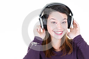 Portrait of happy music lover listening music in headphones with copy space
