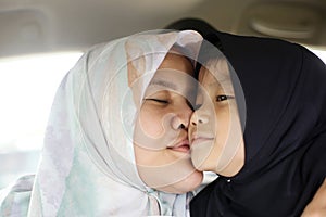 Happy Muslim Mom and Daughter, Asian mother kiss her baby girl