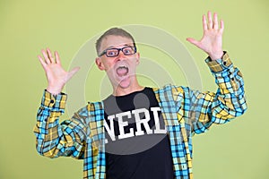 Portrait of happy nerd man with eyeglasses looking surprised
