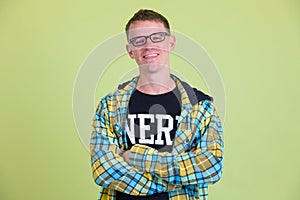 Portrait of happy nerd man smiling with arms crossed