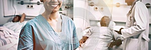 Portrait of happy nurse standing in hospital room