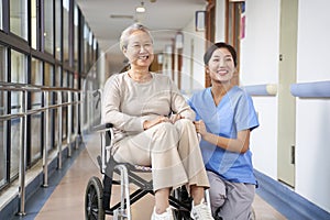 Portrait of happy nursing home resident and caregiver