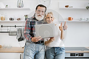 Portrait of happy old married couple shopping online for delicious breakfast.